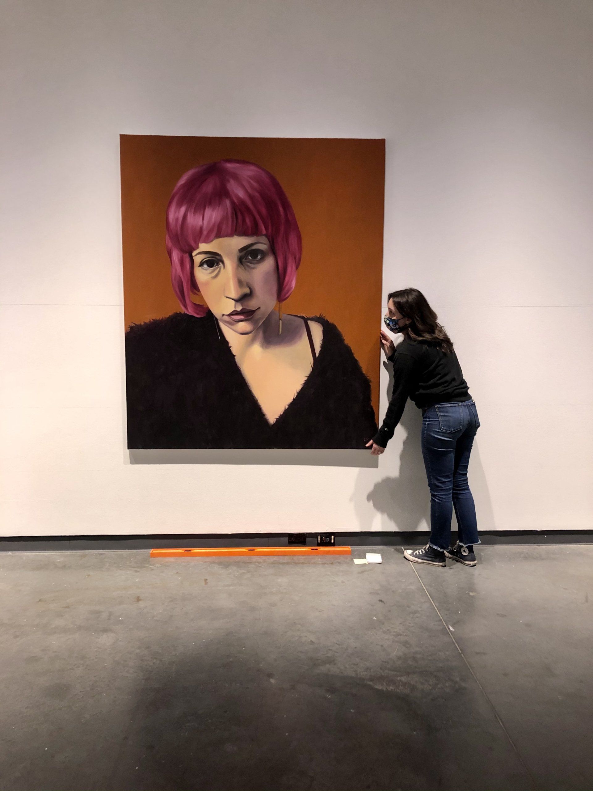 curator installing painting for 