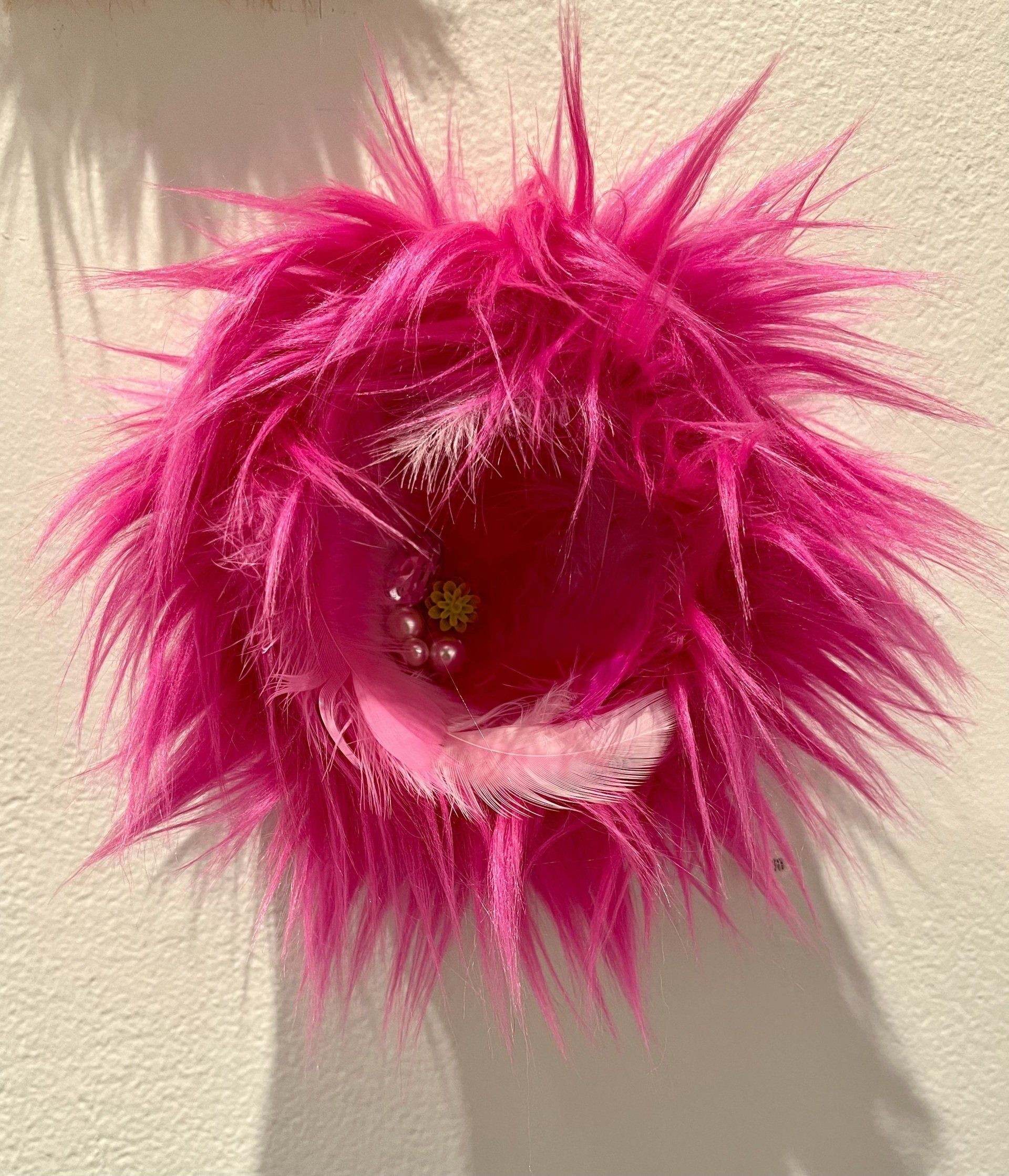 pink feathered, furry piece of artwork 