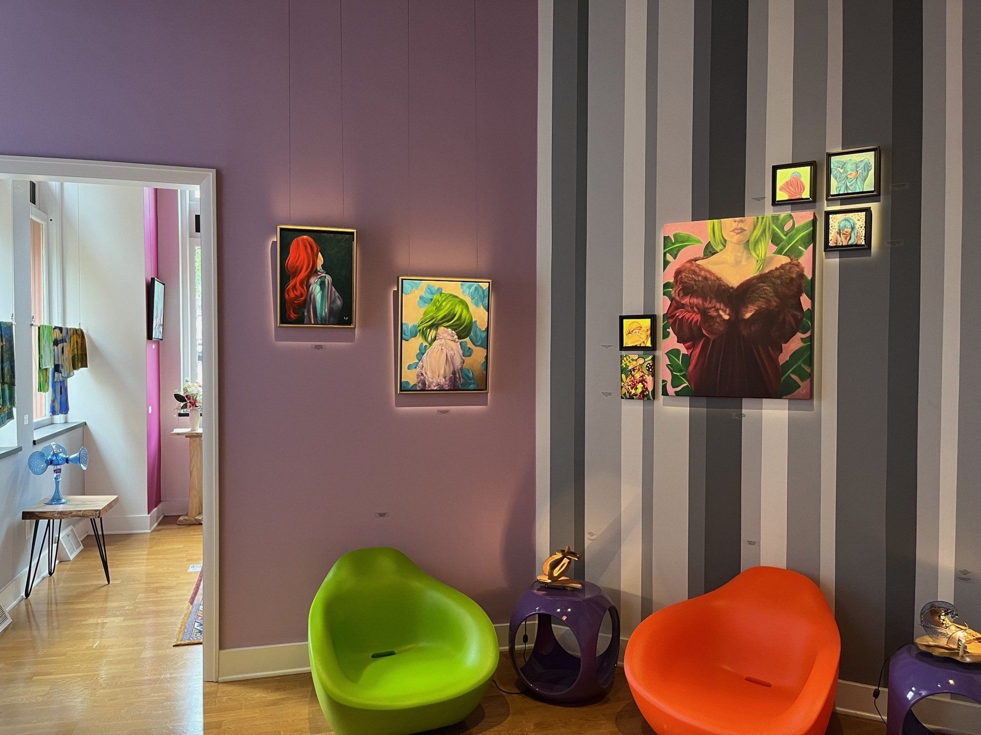 Gallery that looks like a living room with the artists' paintings of varying sizes, Bethlehem House Gallery 2022