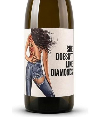 Bottle label with illustrated woman and bold text, “She Doesn’t Like Diamonds.”