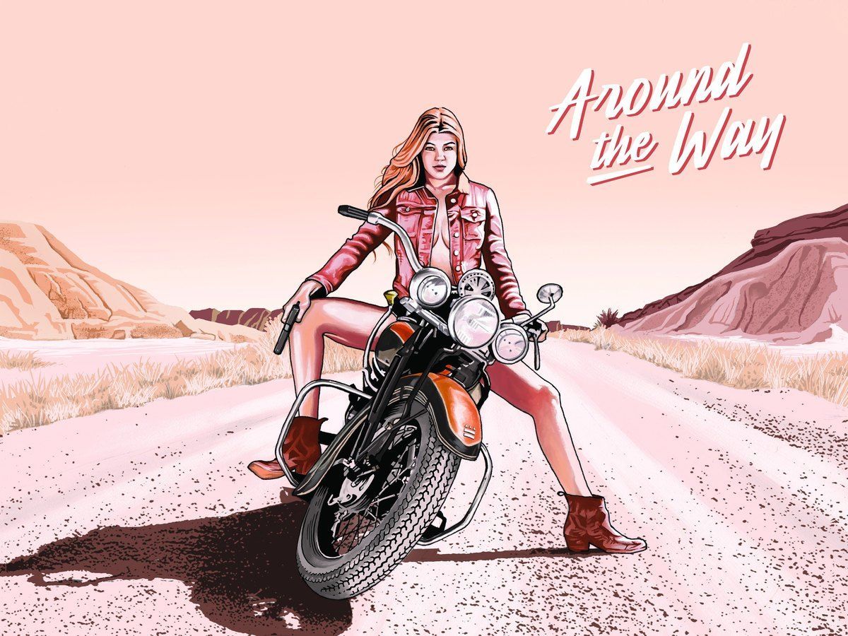Woman in pink stands with a motorcycle on a desert road under a pink sky, with “Around the Way” text.