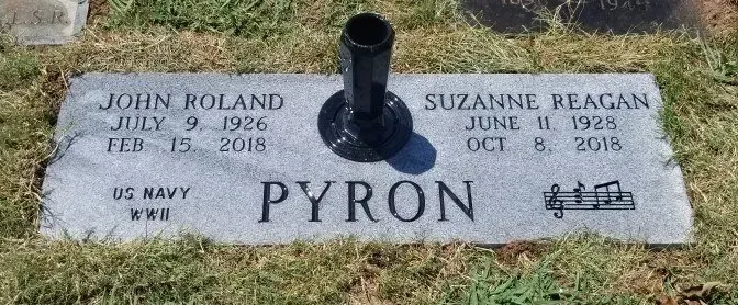 Gravestone for John Roland and Suzanne Reagan Pyron with a black vase in the center.