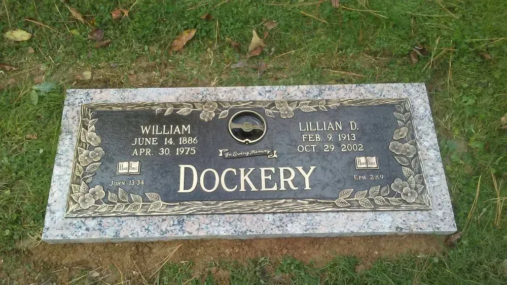 Gravestone plaque in grass with the name “DOCKERY” and gold lettering.