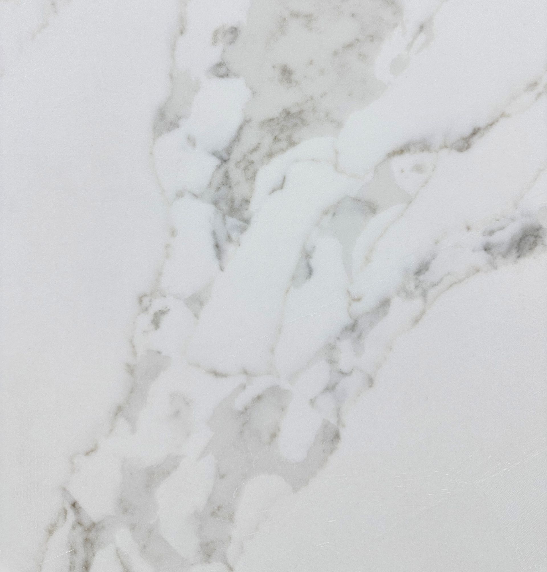 White quartz surface featuring gray, marble-like veining patterns.