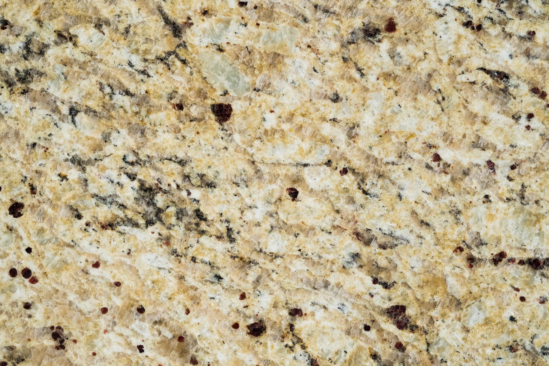 Beige and tan granite countertop with dark speckles.