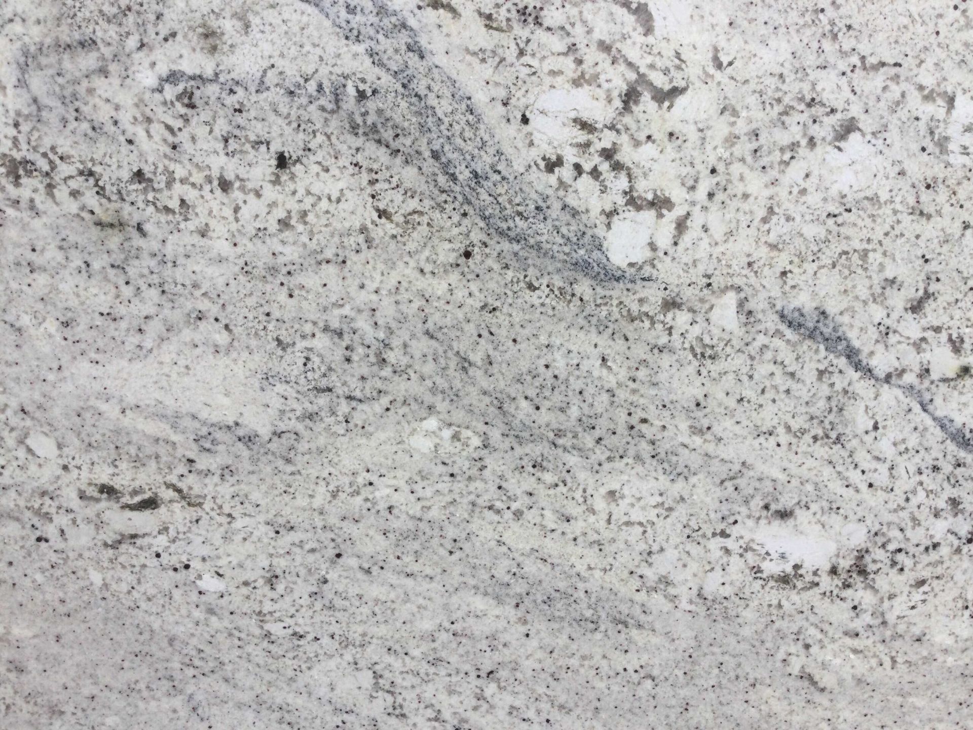 White granite countertop with gray and black speckles.