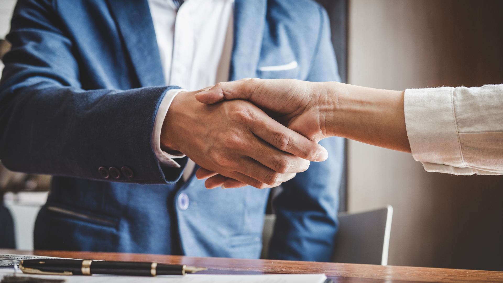 Blue mountain range with sun rays shining through. Forest in the foreground.