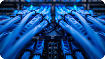 Blue network cables plugged into a server in a data center. Blue network cables plugged into a server in a data center.