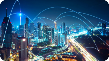 Night cityscape with glowing blue lines connecting buildings, representing network connectivity. Night cityscape with glowing blue lines connecting buildings, representing network connectivity.