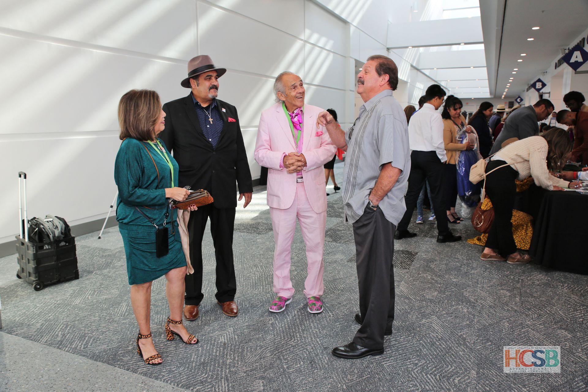 A group of people standing in a hallway with a sign that says hcsb