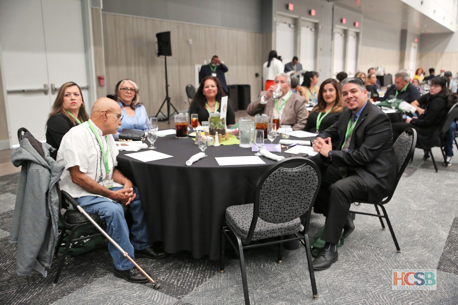 A group of people are sitting at tables in a room.