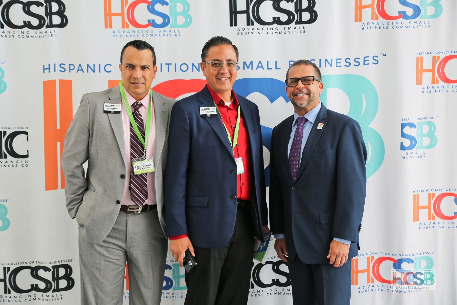 Three men in suits and ties are posing for a picture.