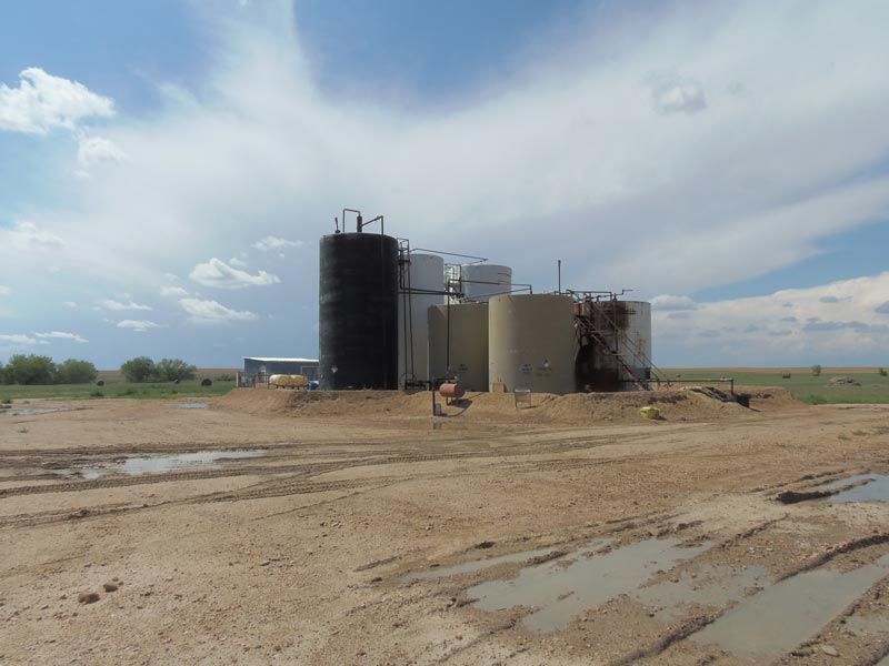 A large building in the middle of a dirt field