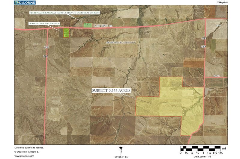 Aerial map showing a rural landscape with marked land parcels, roads, and a scale bar.