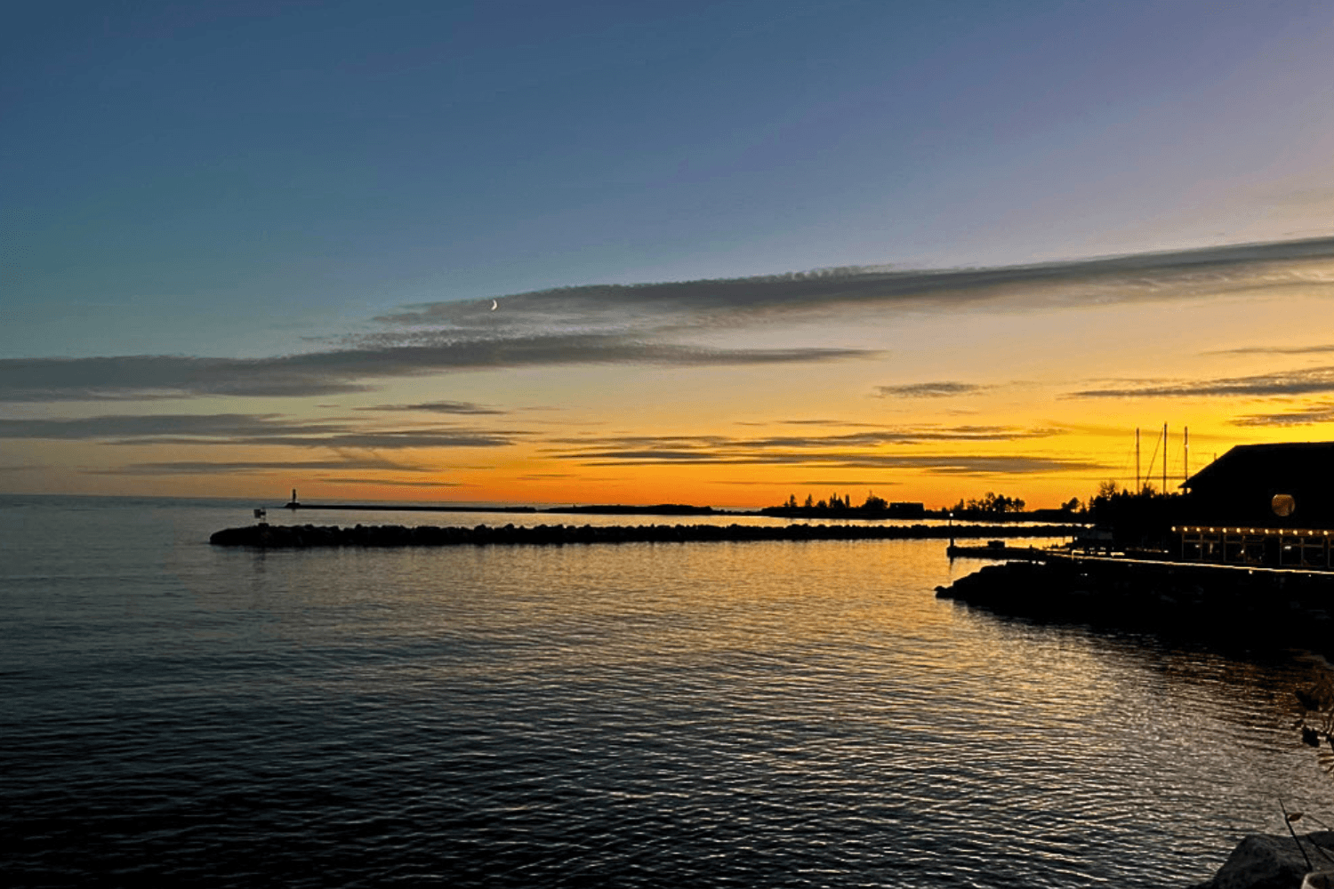 View of the Grand Marais Harbor in the middle of the town on a fall evening at sunset.