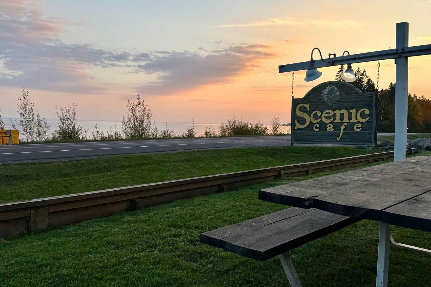 The sign for the New Scenic Cafe at sunset
