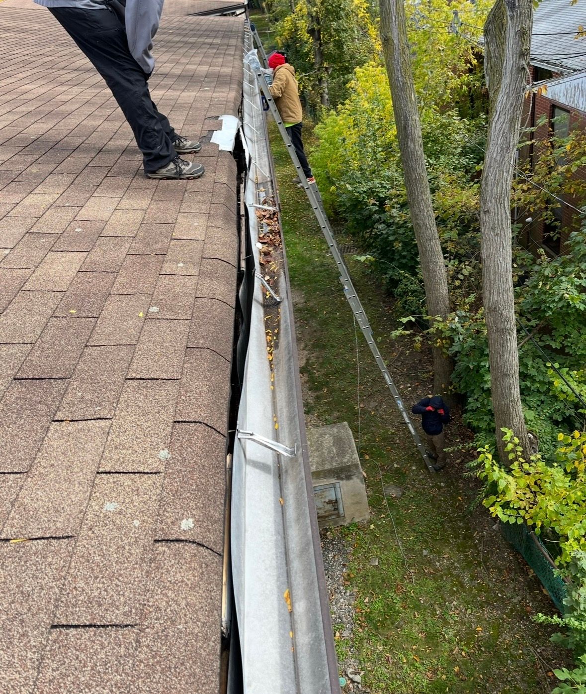 Pressure washing a house's siding, spraying water.