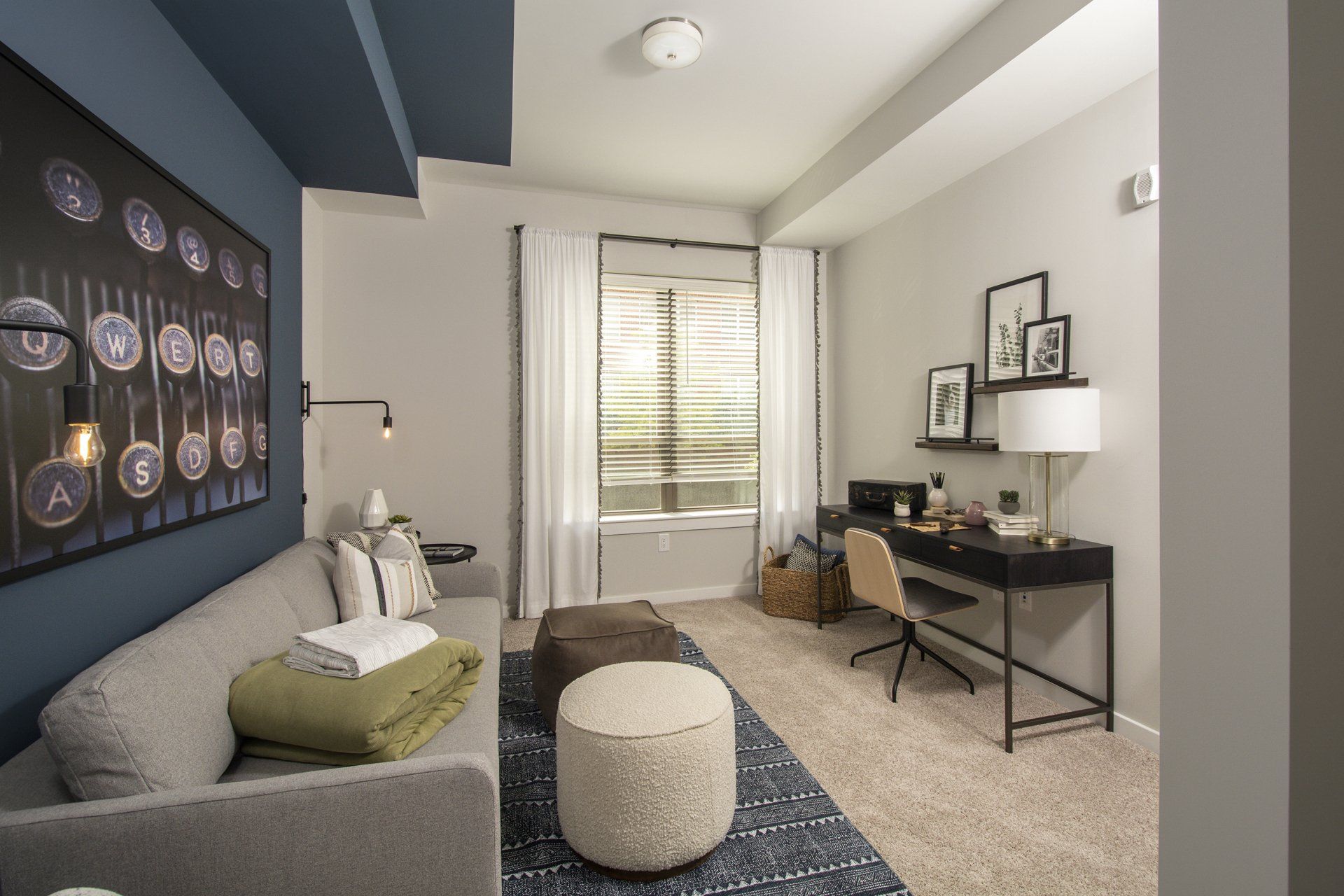 Furnished living room with large windows and plus carpeting