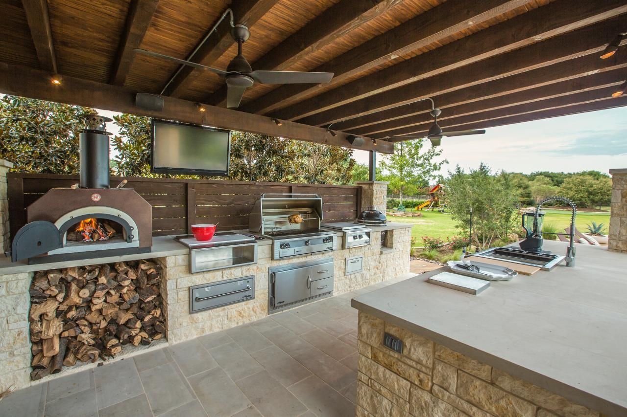 there is a pizza oven in the middle of the kitchen .