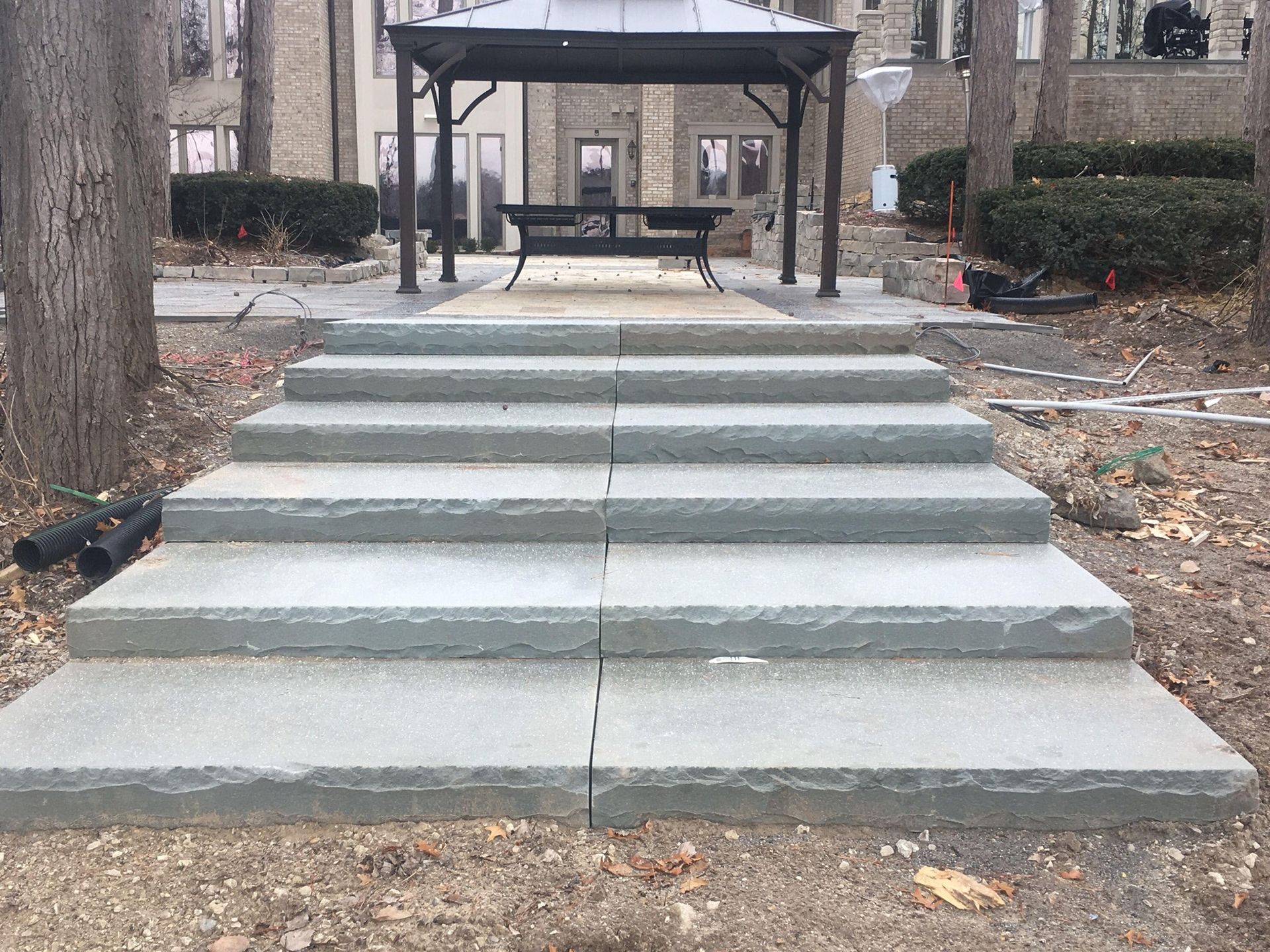 a set of stairs leading up to a gazebo in a yard .