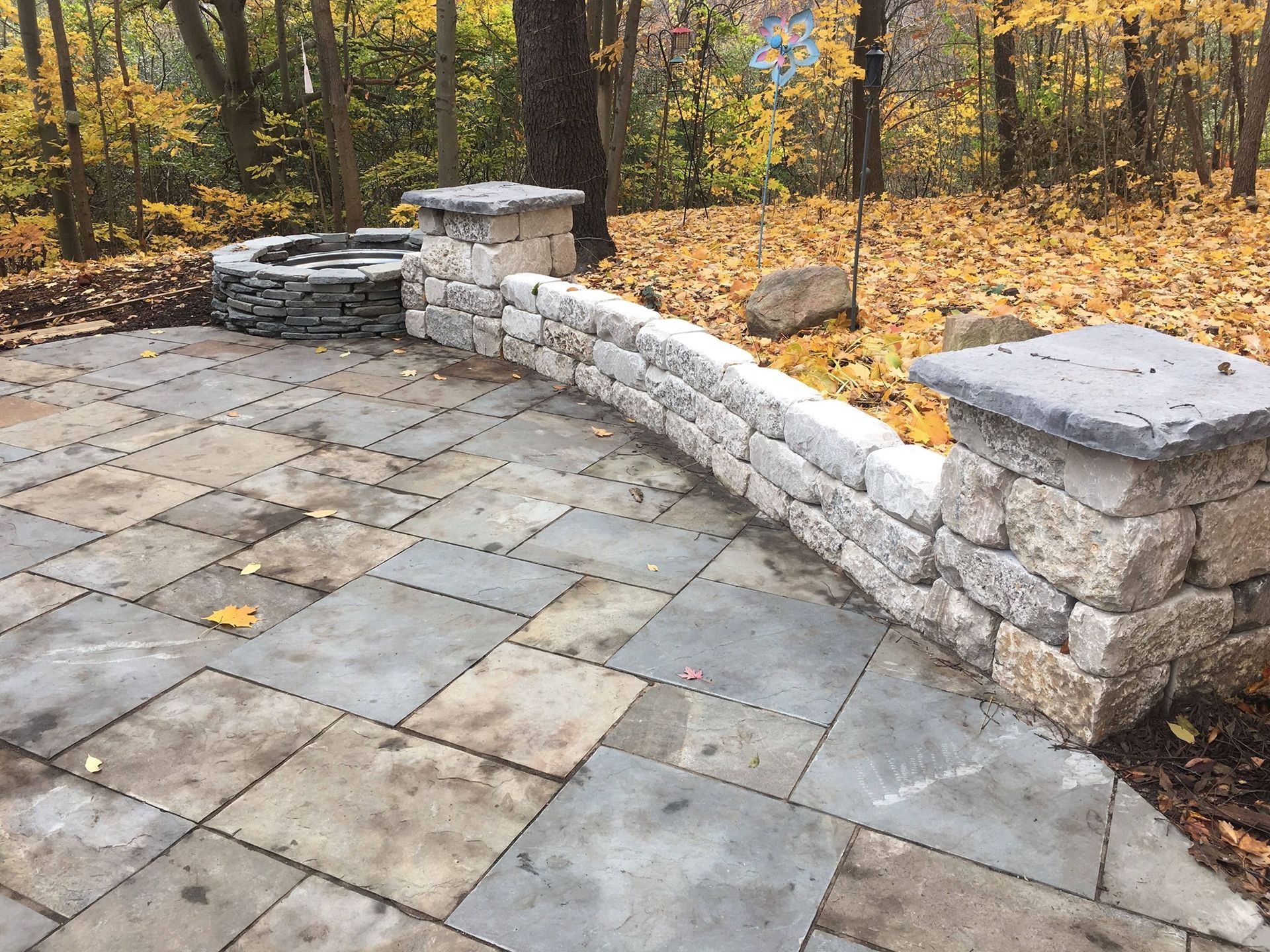 there is a fire pit in the middle of the patio .