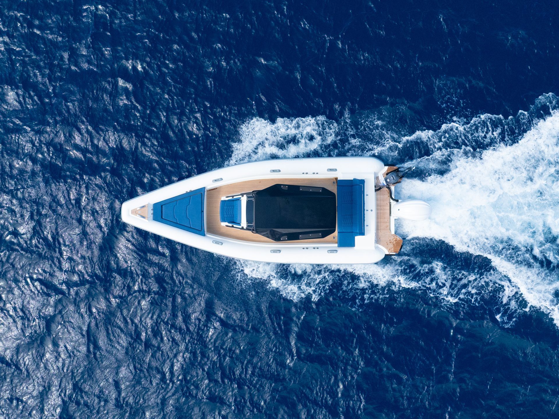 Private Rib Speeboat cruising across the deep blue sea in Mykonos