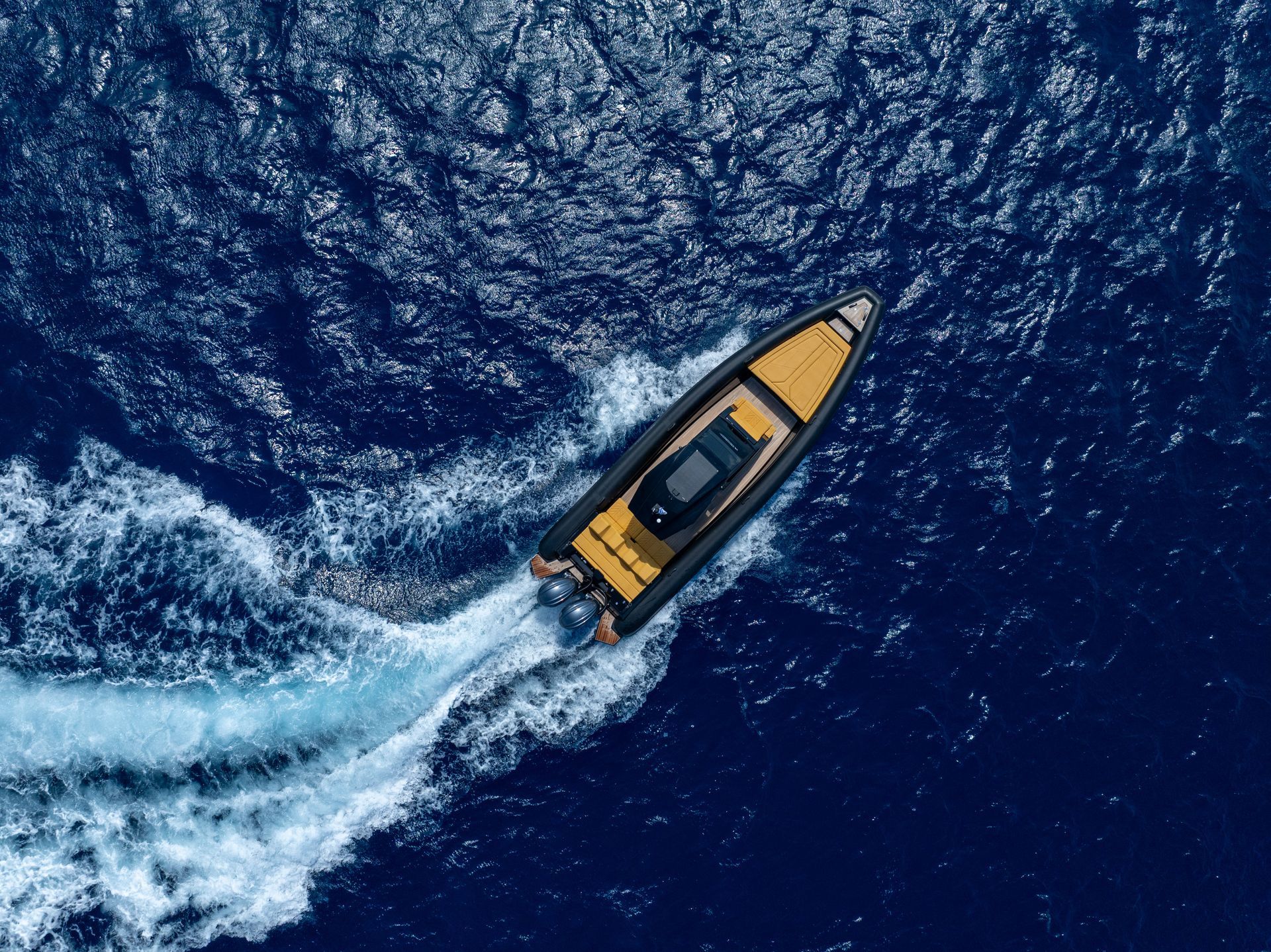 Luxury RIB speedboat cruising at speed for a private charter in Mykonos