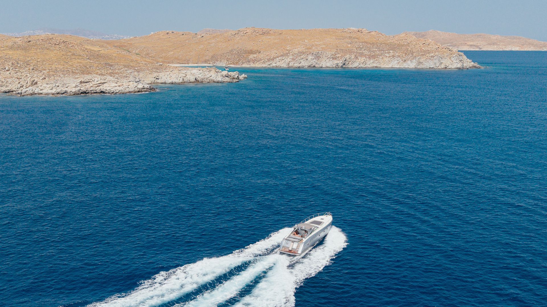 Private boat charter cruising near the Mykonos coastline