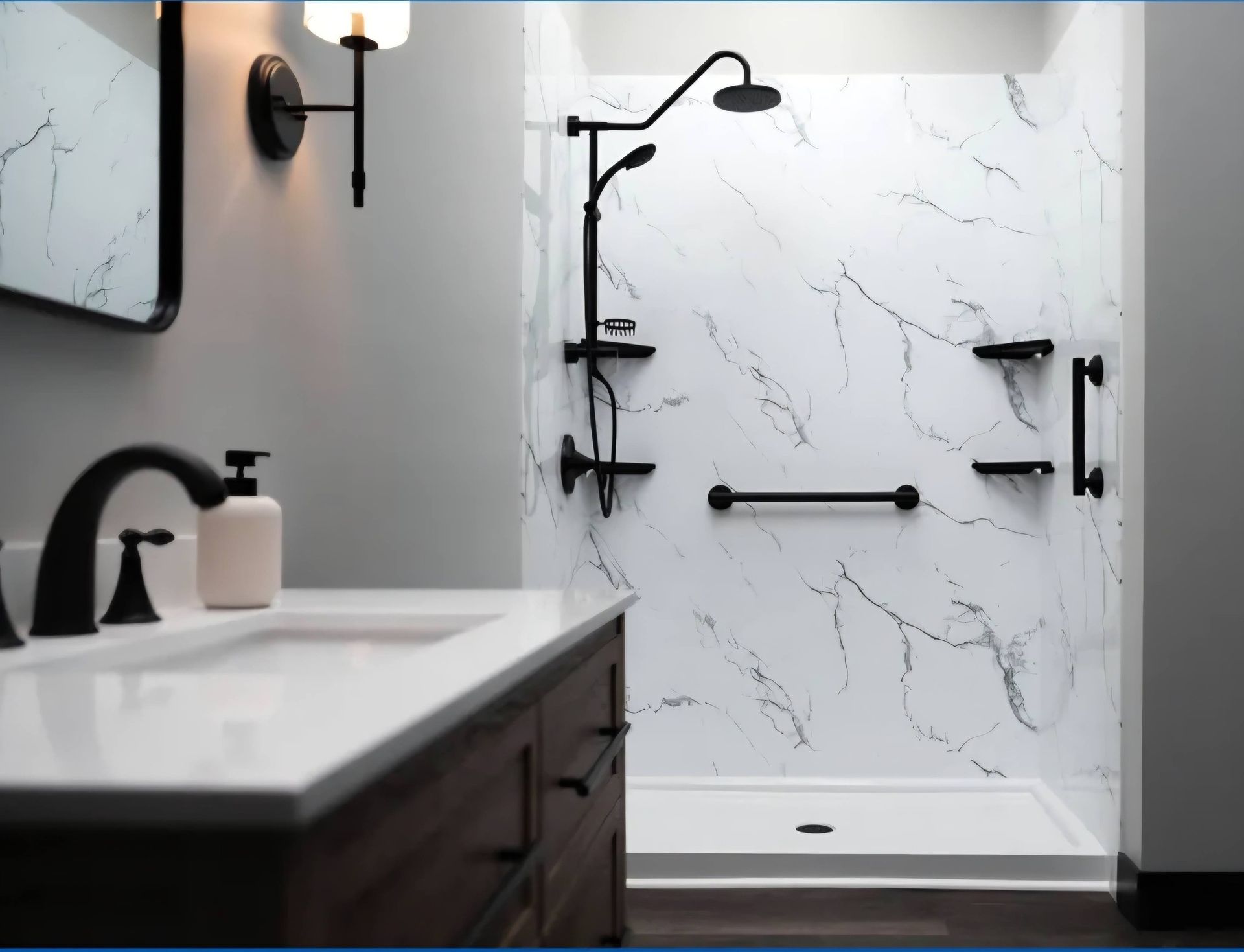 A bathroom vanity next to a walk-in shower featuring marble-patterned walls, black fixtures, and grab bars.