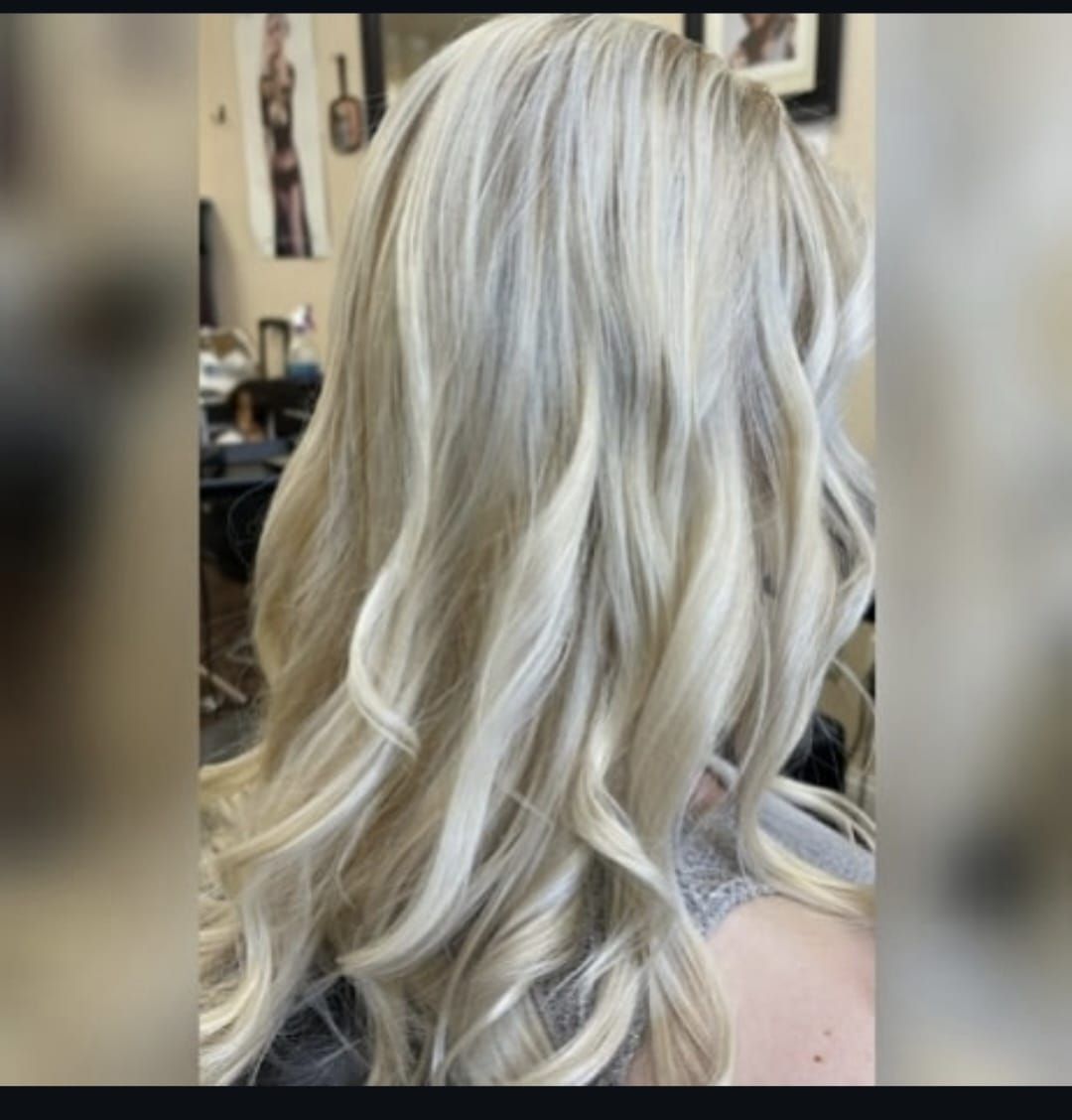 Back view of long platinum blonde wavy hair in a salon chair