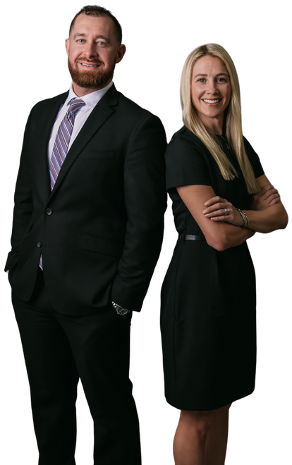 A man and a woman are standing next to each other with their arms crossed.
