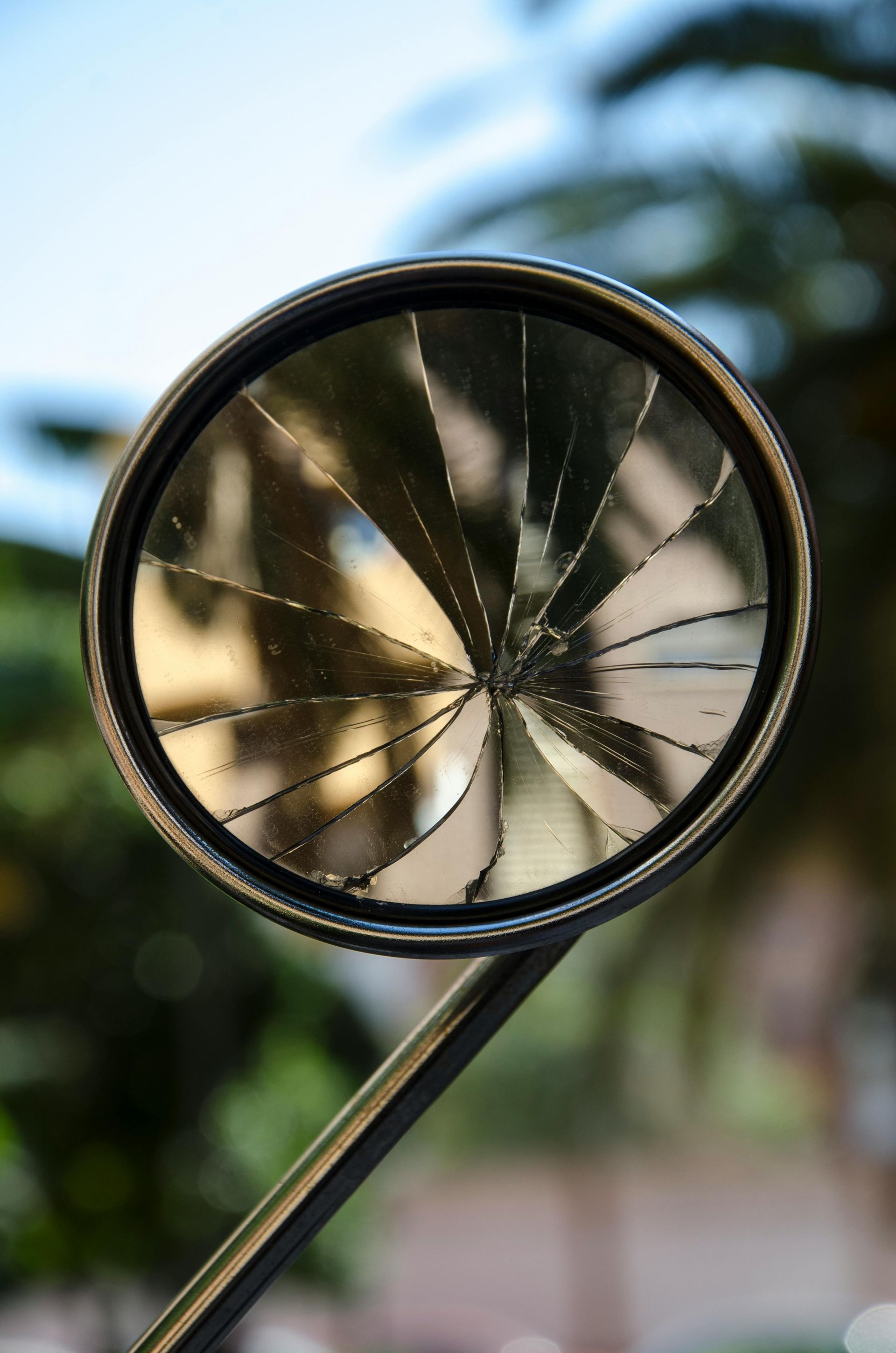 A close up of a broken rear view mirror on a motorcycle