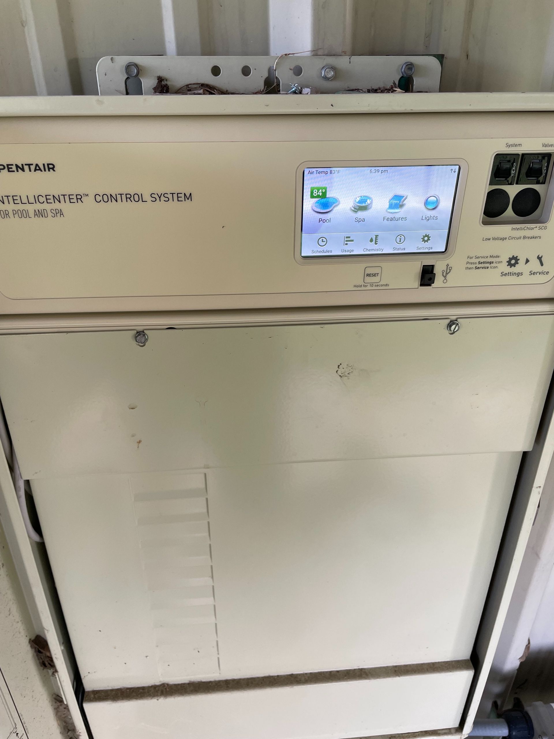 White industrial machine with a small touchscreen control panel and dials on the front.