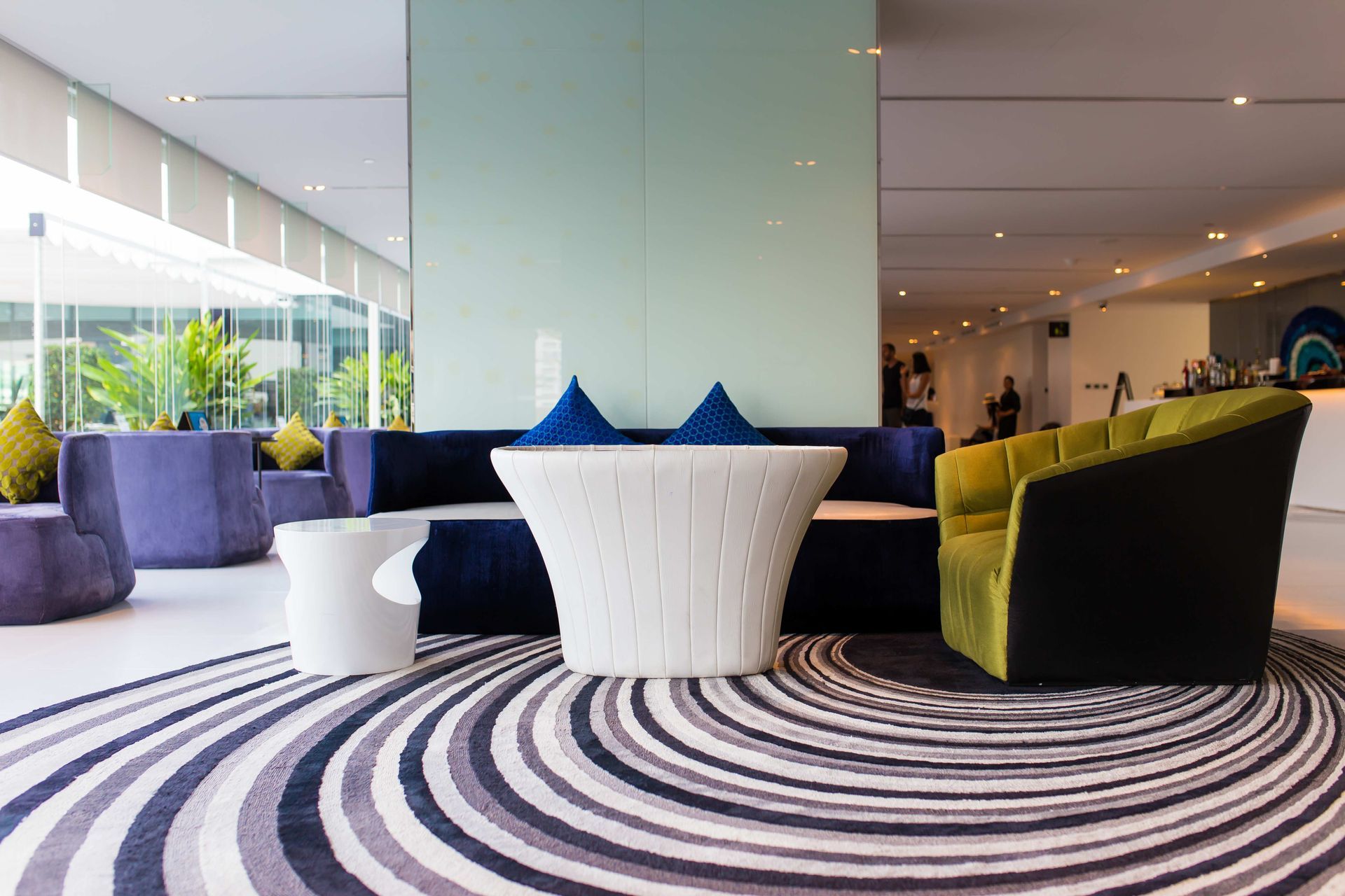 a living room with a couch , chair , table and a striped rug