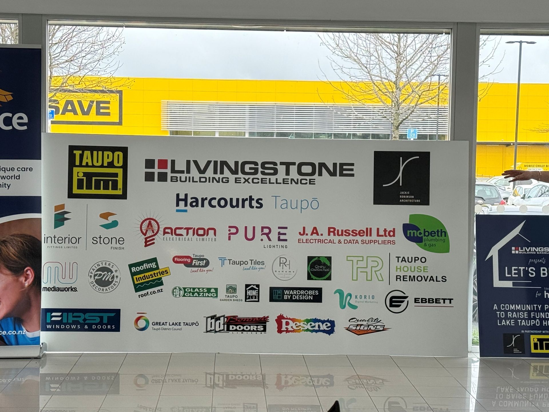 Sign with logos for various businesses, including