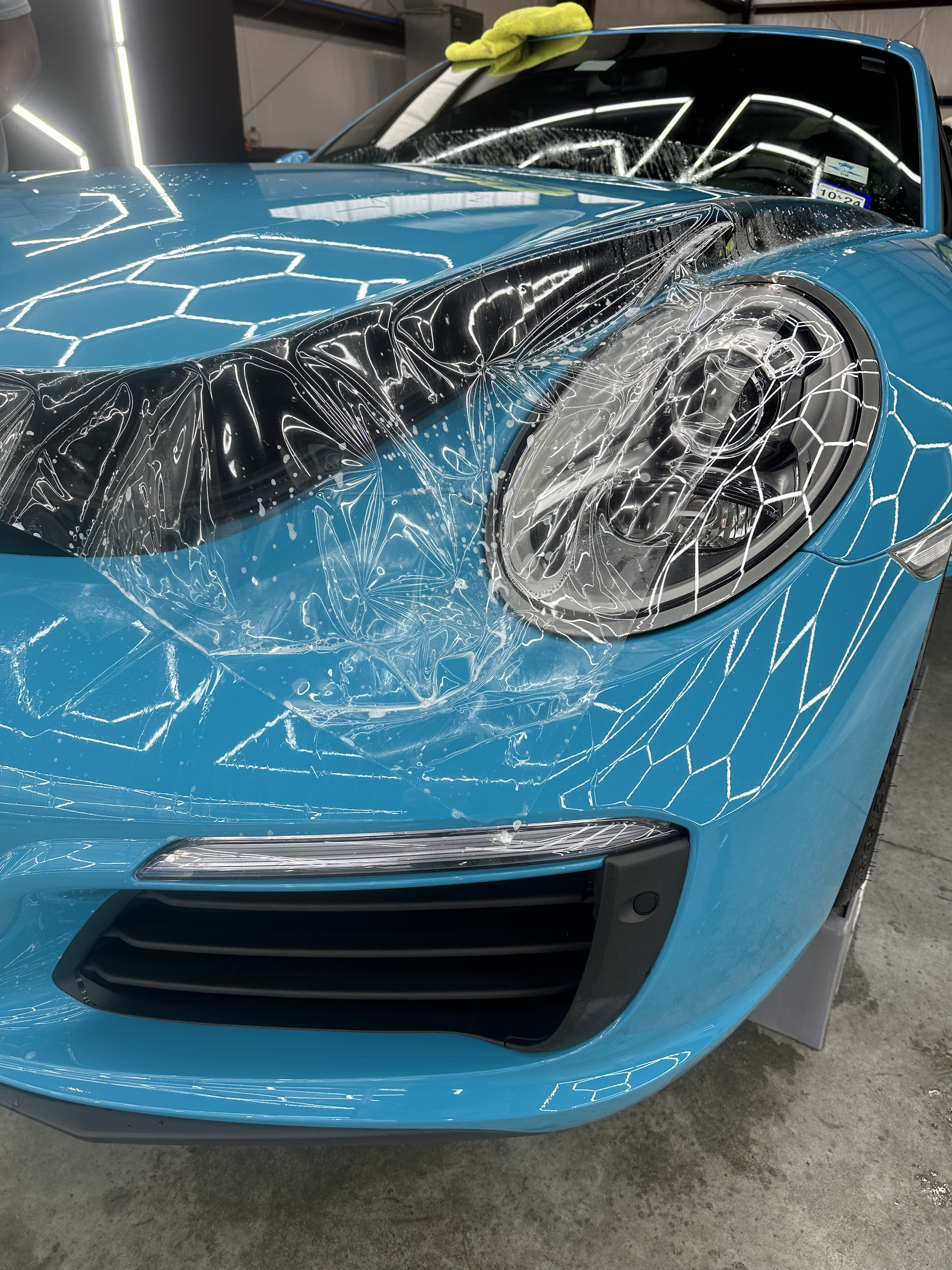 A black sports car is parked on the side of the road