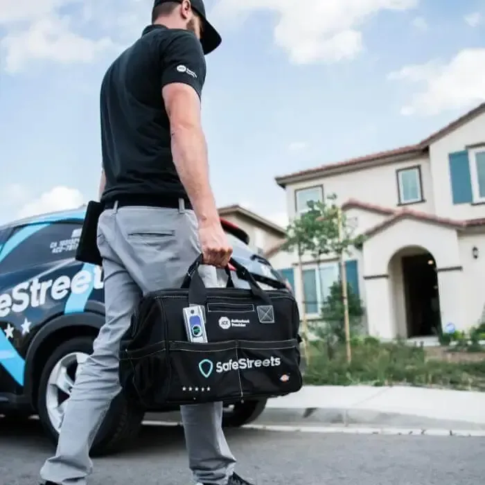 A man carrying a bag that says salesstreets on it