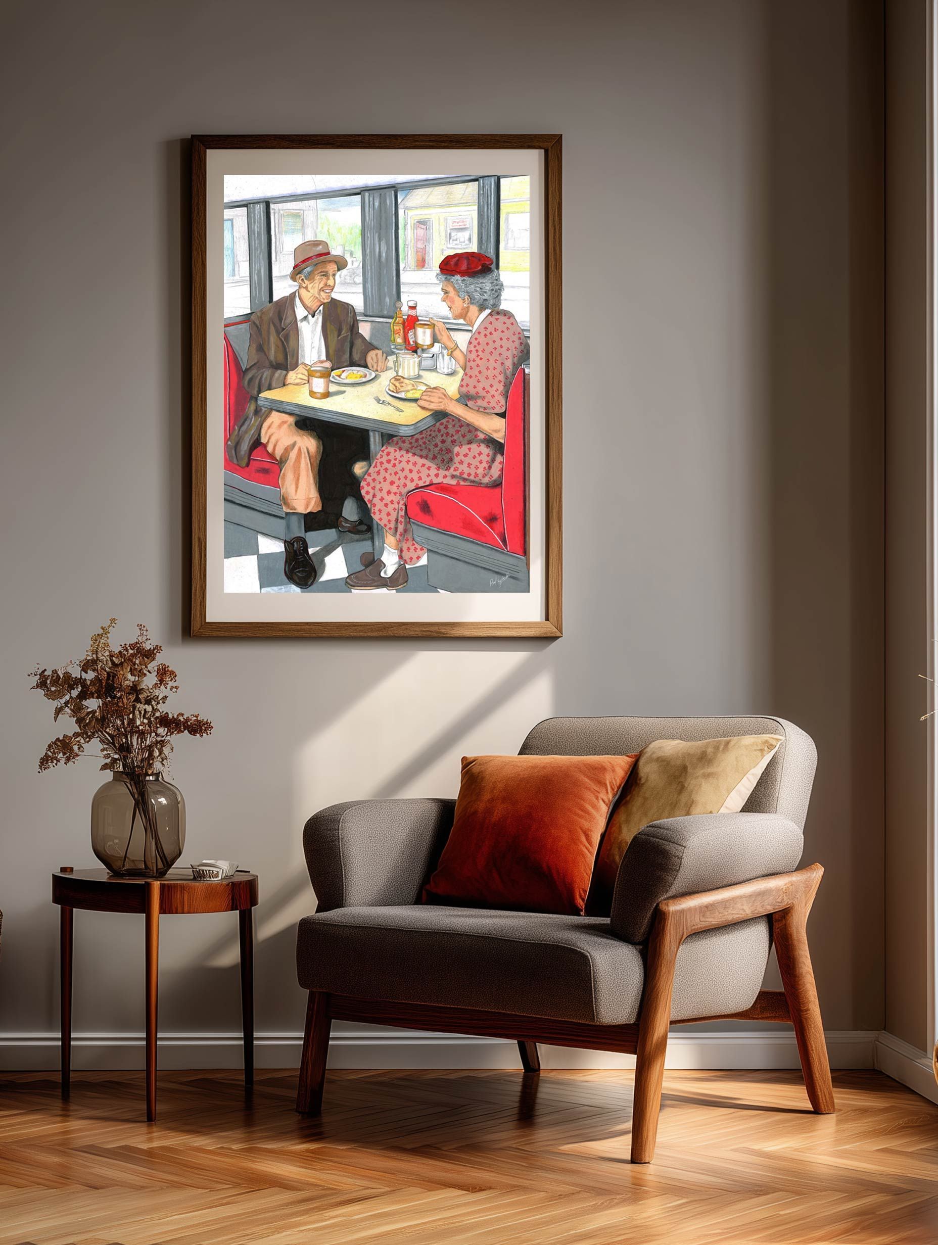 Framed painting above a gray armchair with orange pillow in a warm living room corner.