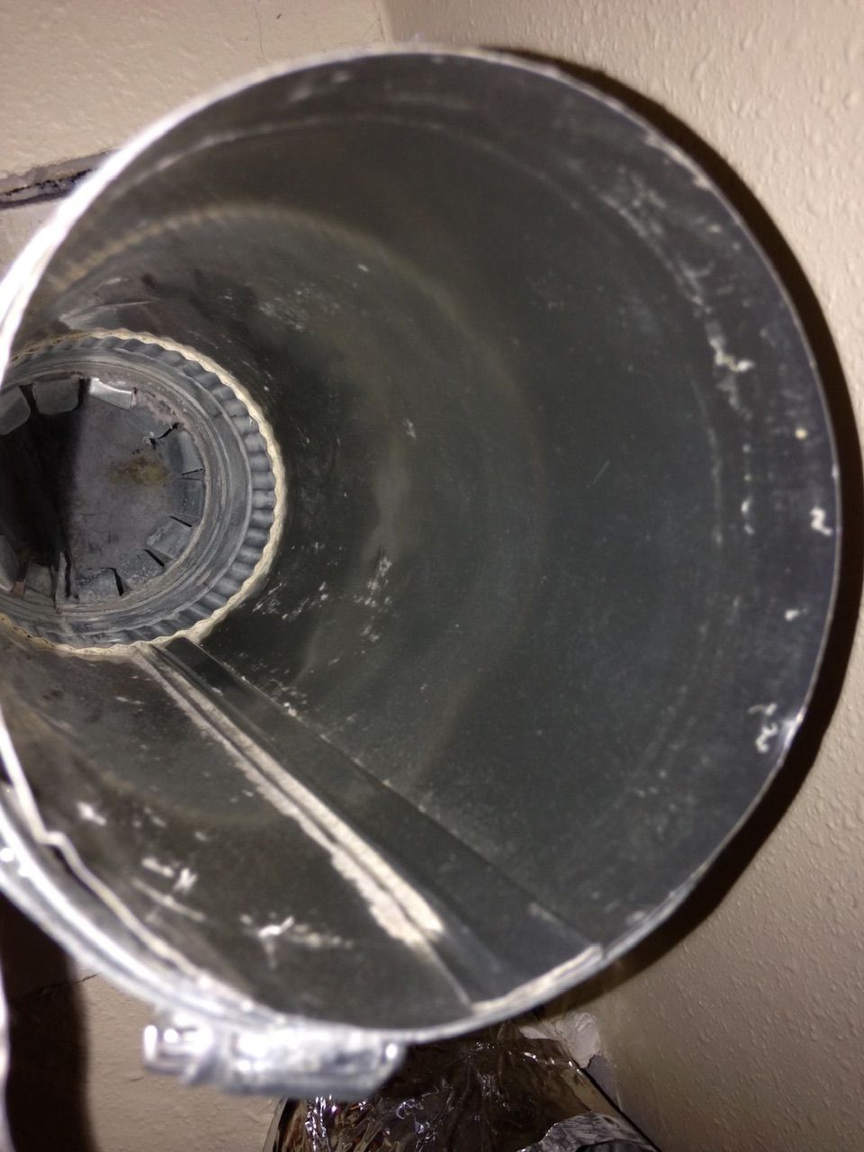A close up of a metal pipe with a hole in the middle.