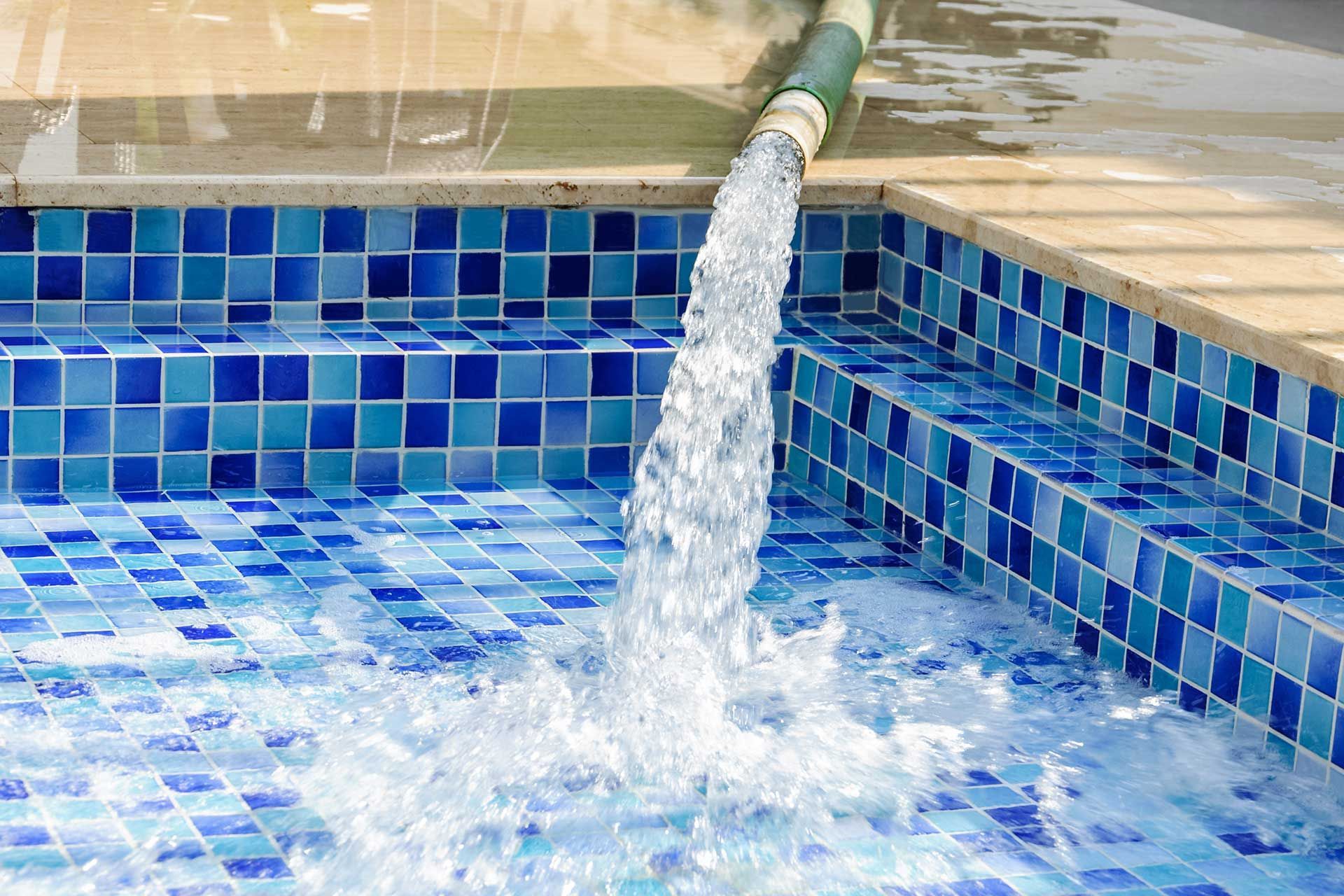 filling the pool with artesian water flowing from the pipe. servicing 
