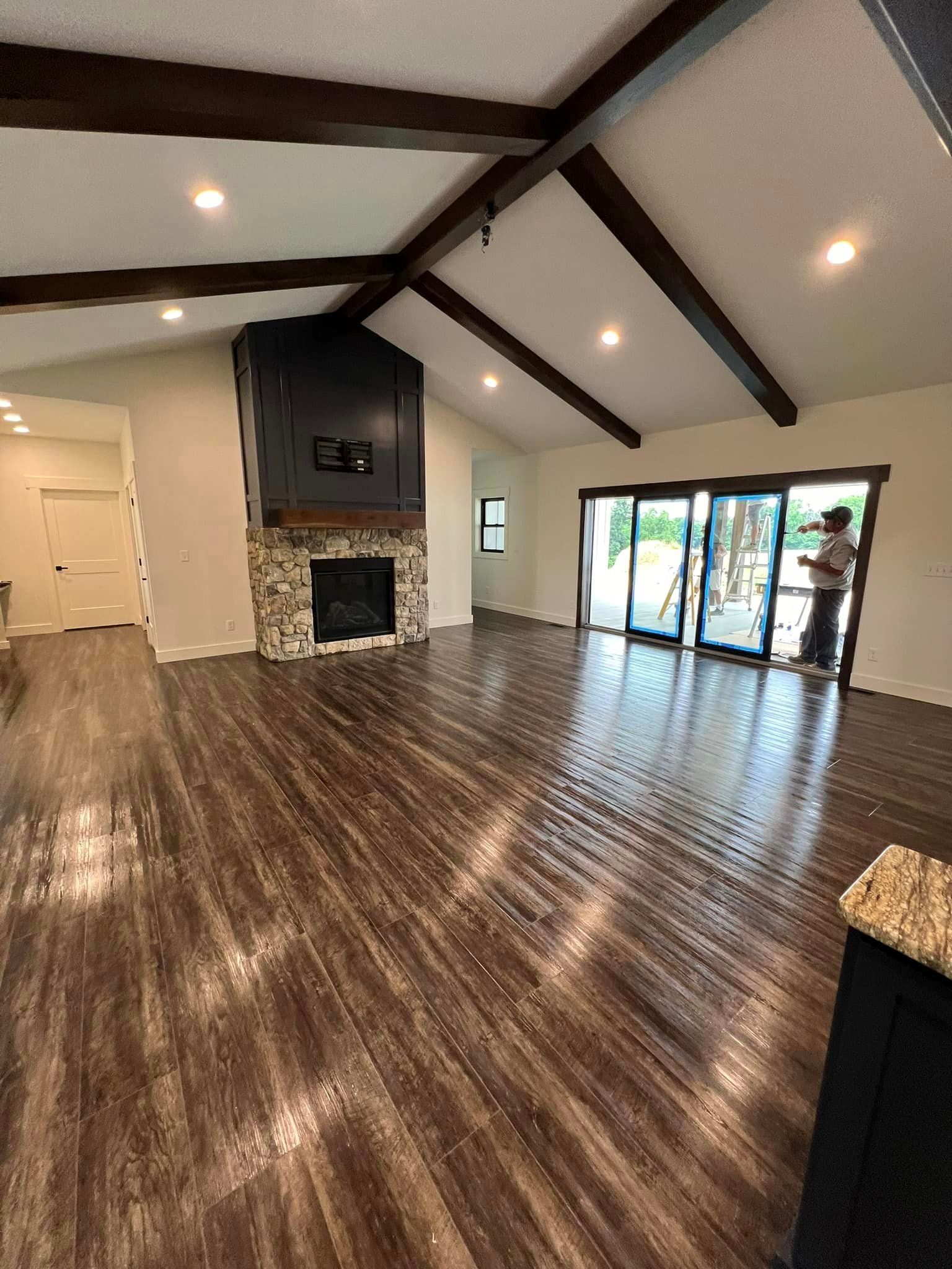 A living room with a fireplace and sliding glass doors.
