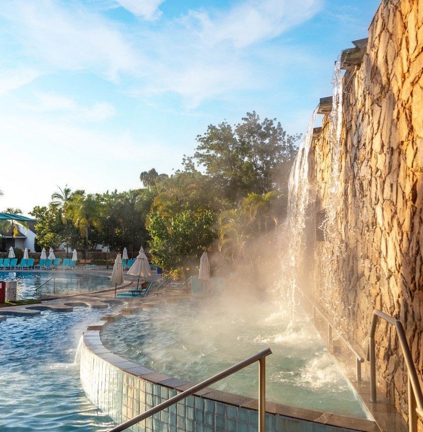 Uma piscina com uma cachoeira ao fundo