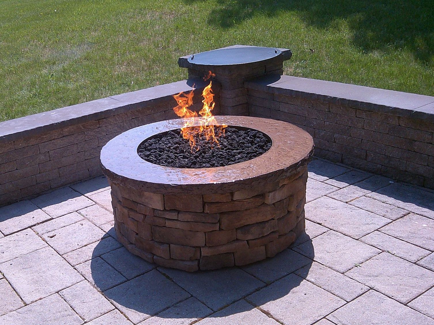 A fire pit with flames coming out of it