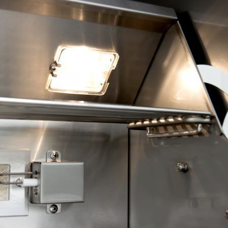 A stainless steel cabinet with a light on top of it