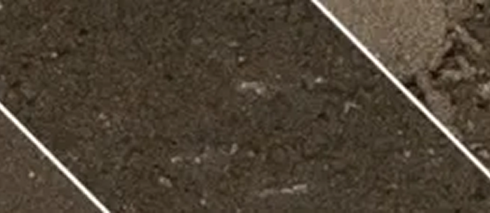 A close up of a brown tile floor with a white line.