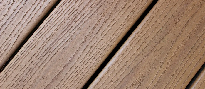 A close up of a wooden deck with a diagonal pattern.