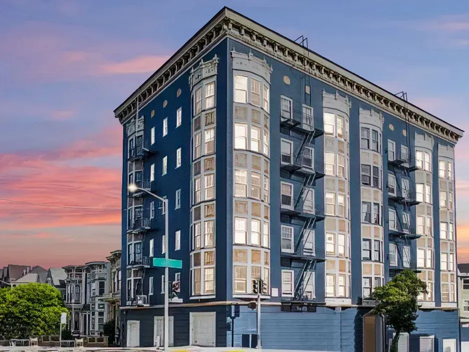 Mid-rise condominium building with bay windows at sunset
