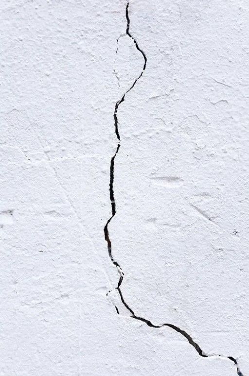 Crack in a white wall.