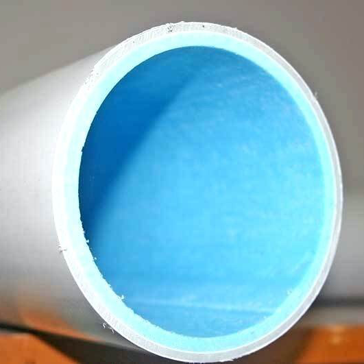 Cutaway view of a white pipe with a blue interior and thin, white rim.