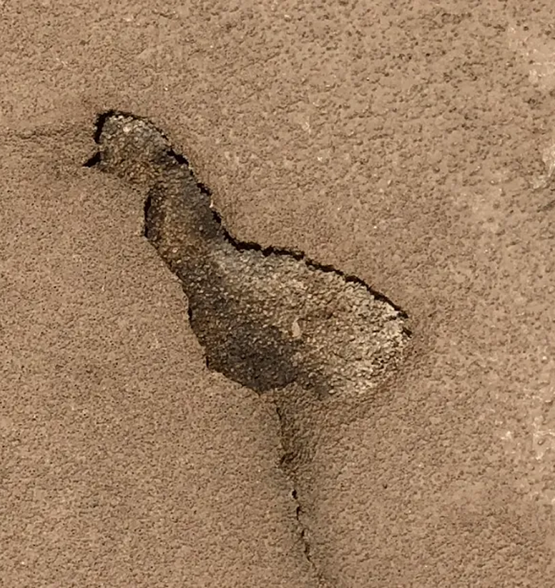 A close up of a concrete surface with a hole in it